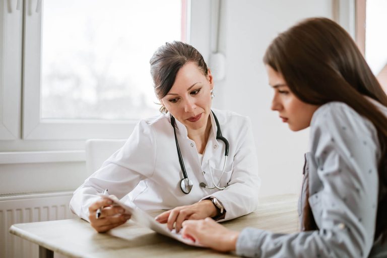 doctor showing documents to a female patient